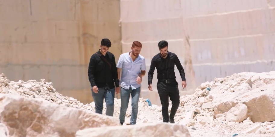 Three men walking in a stone quarry