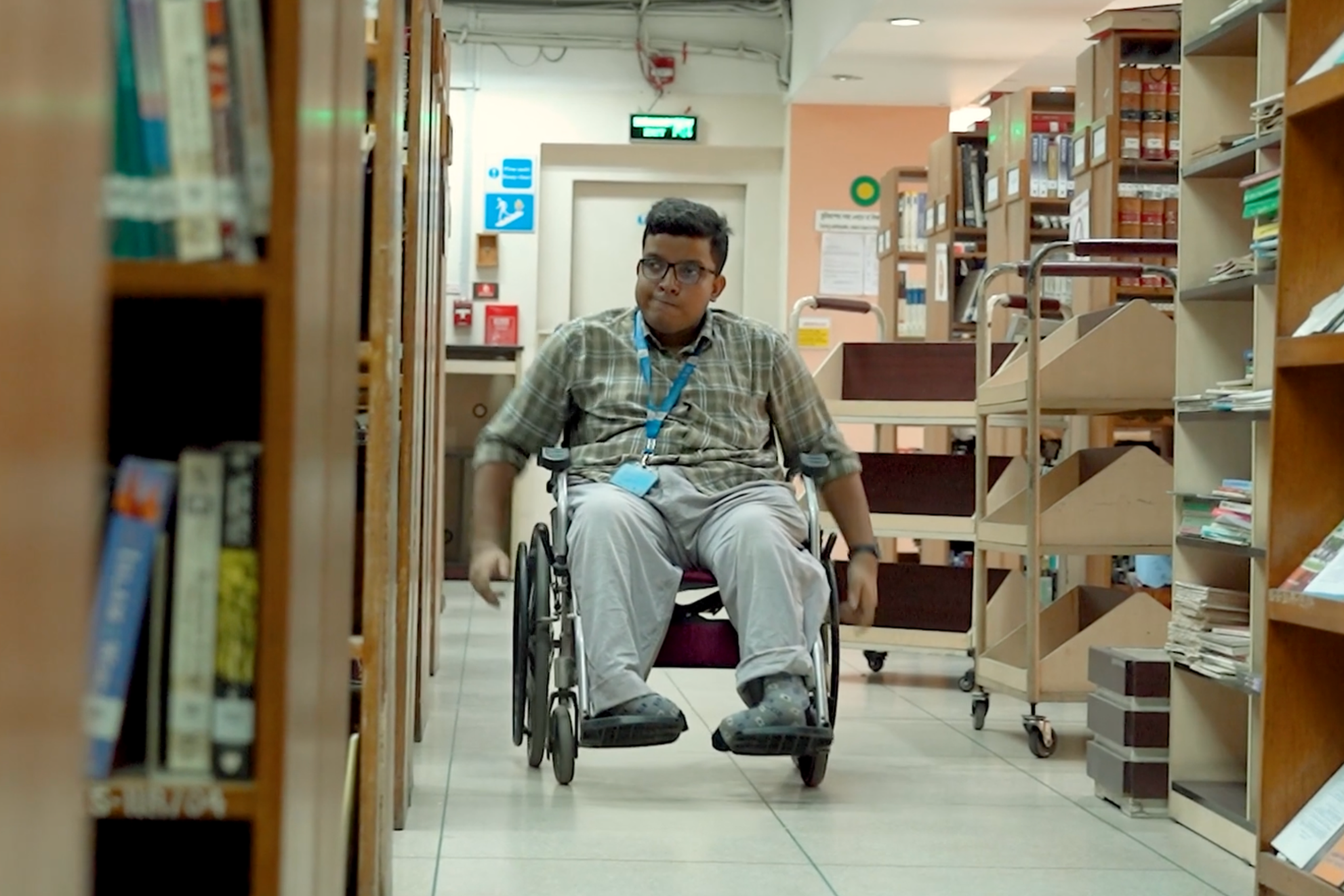 Rahim Bhuiyan on a wheelchair in Brac university library