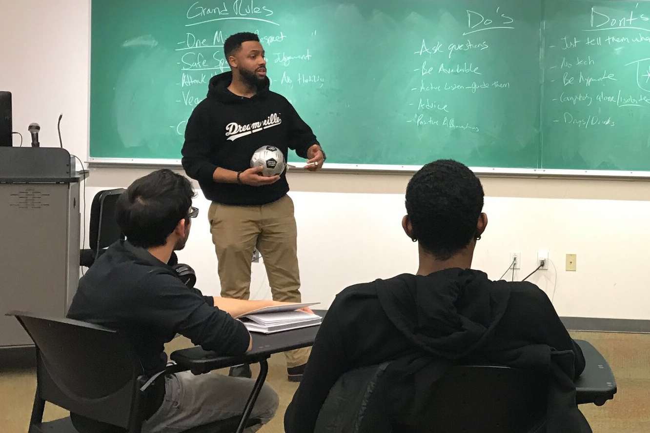 Still from Brothers At case study, Dariel Vasquez speaking in front of classroom