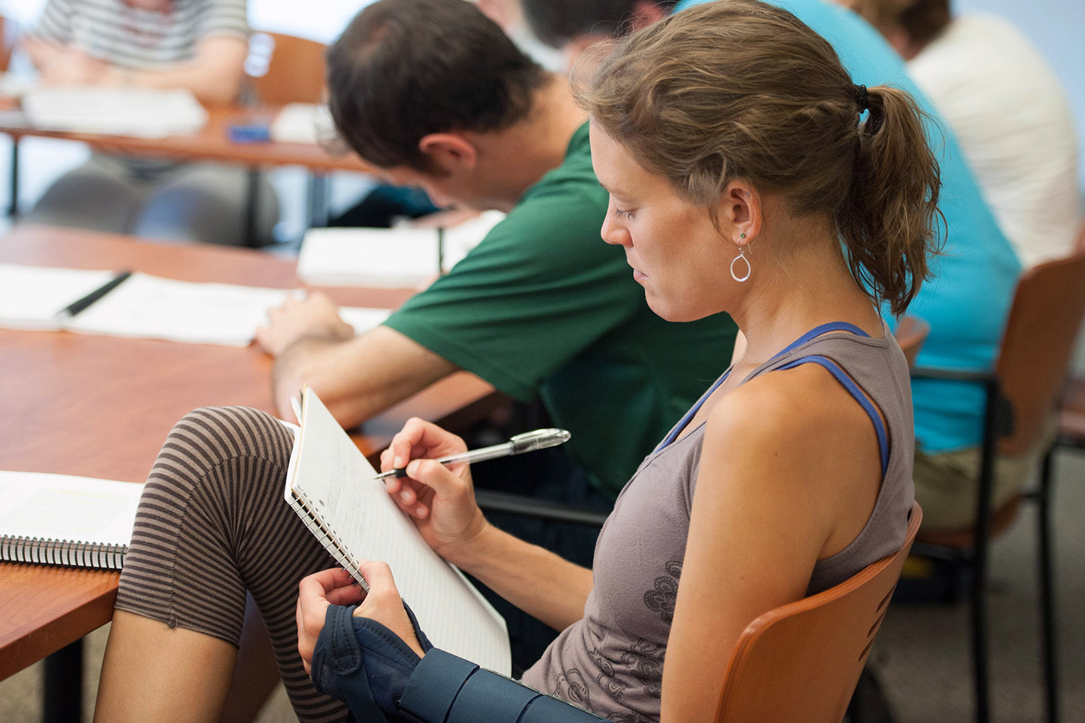 Woman writing in notepad