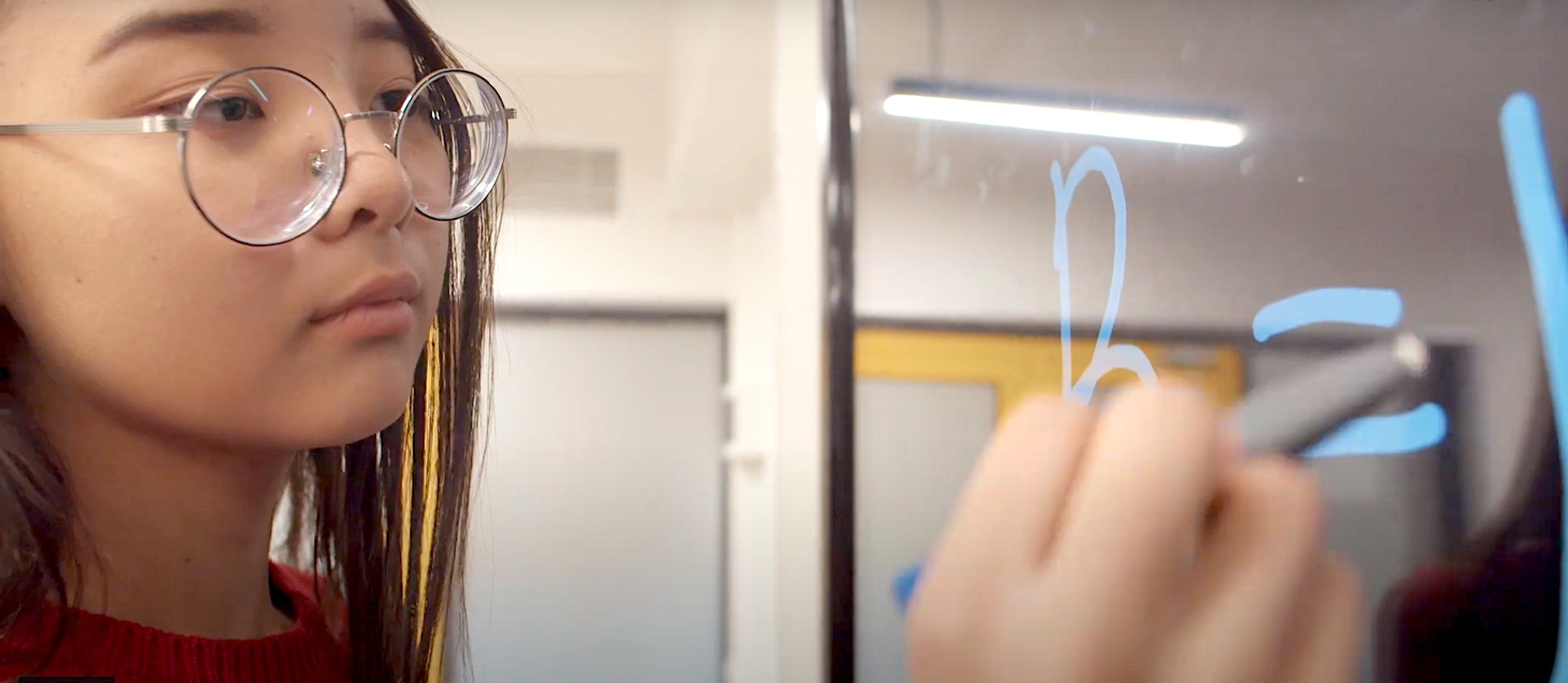 Girl writing on a board