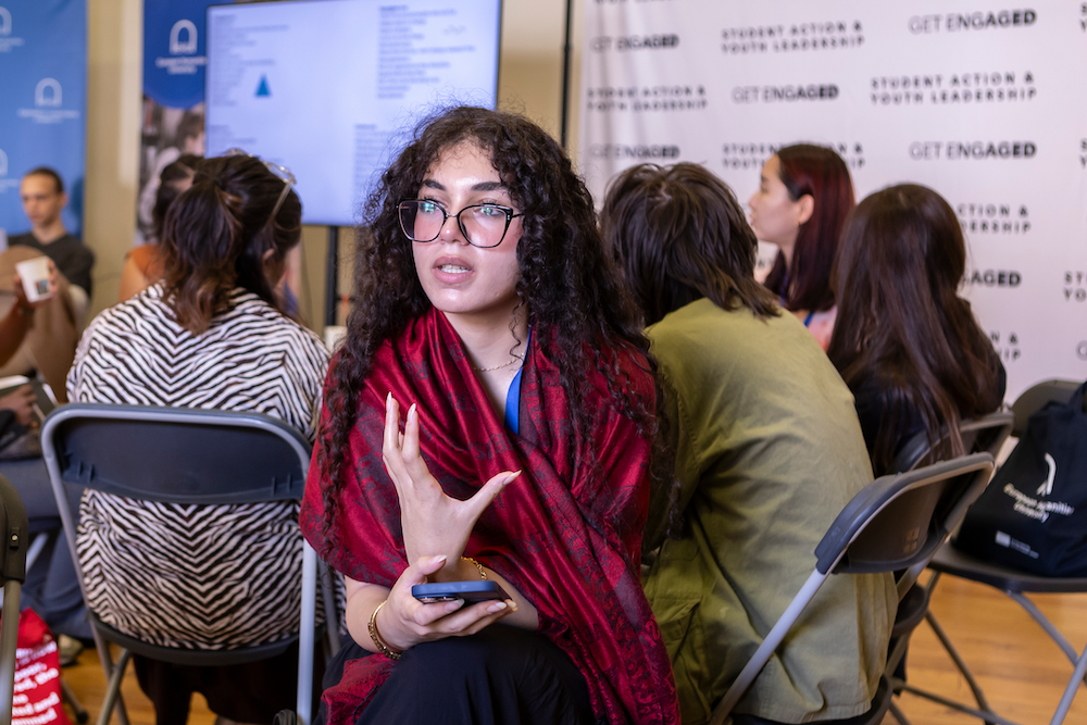 Students gesturing and talking at Get Engaged 2025 conference