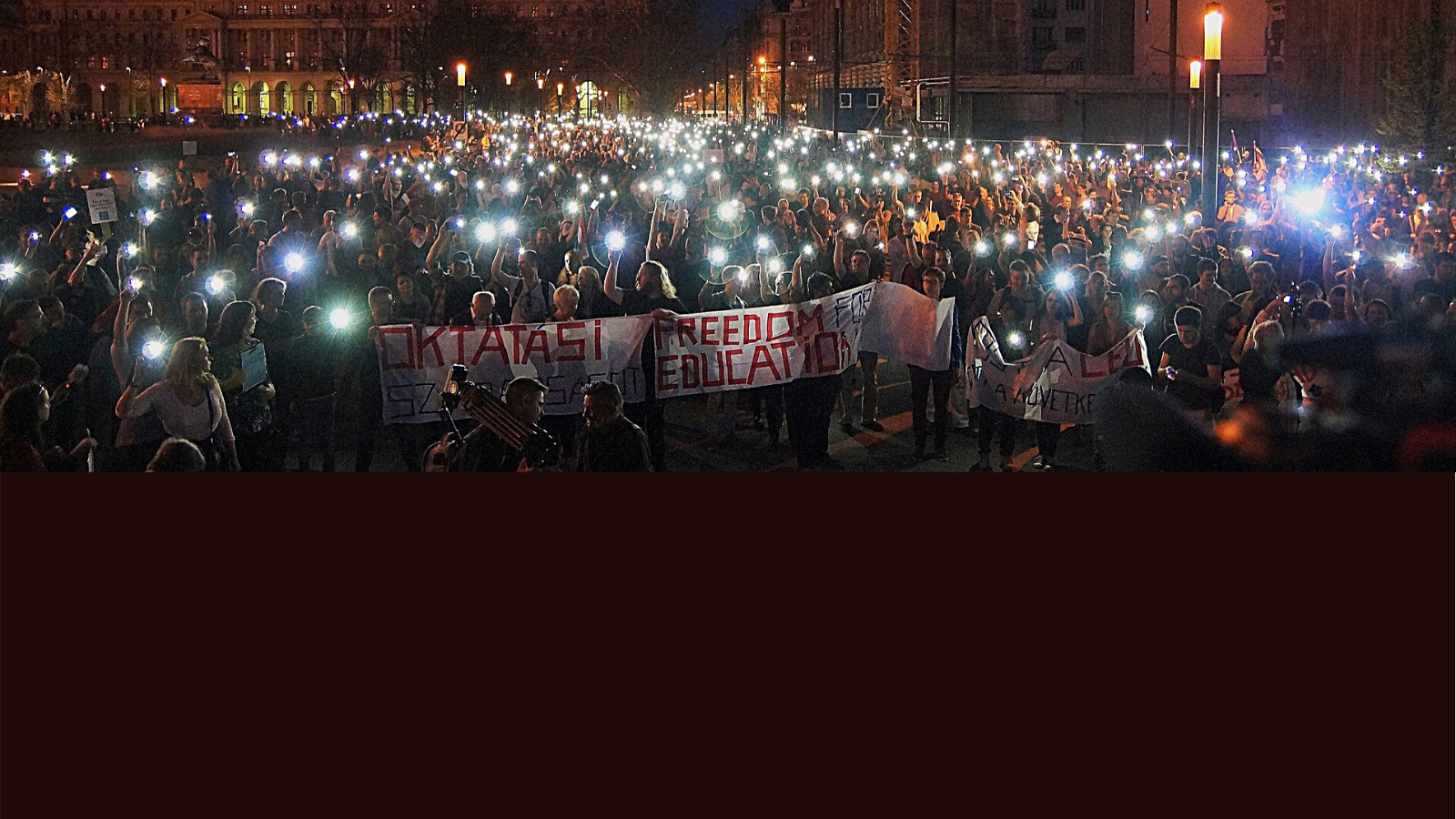 A crowd shining telephone flashlights during a protest