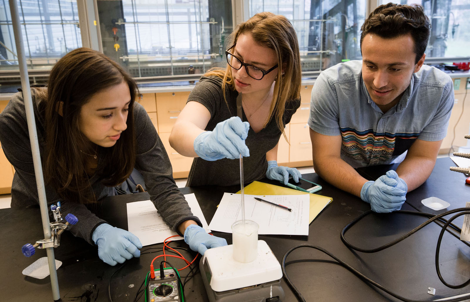Three people working in a science lab