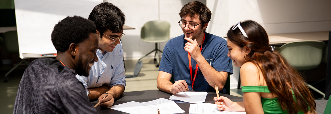 Four students working together around a table at Get Engaged conference