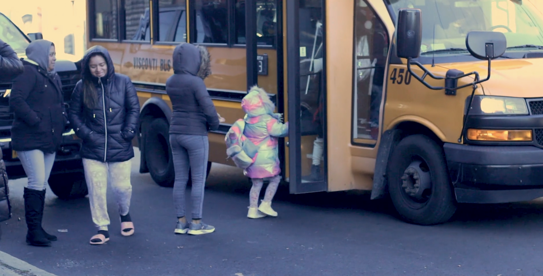 Little girl getting on a school bus