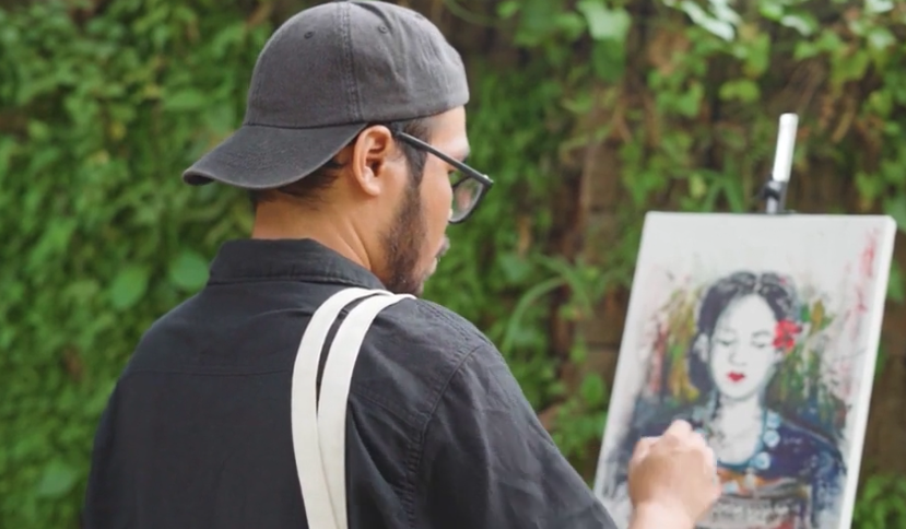 Tufan Chakma, a young artist, painting